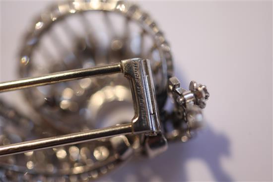 A 1950s Cartier platinum and diamond clip brooch, approx. 2in.